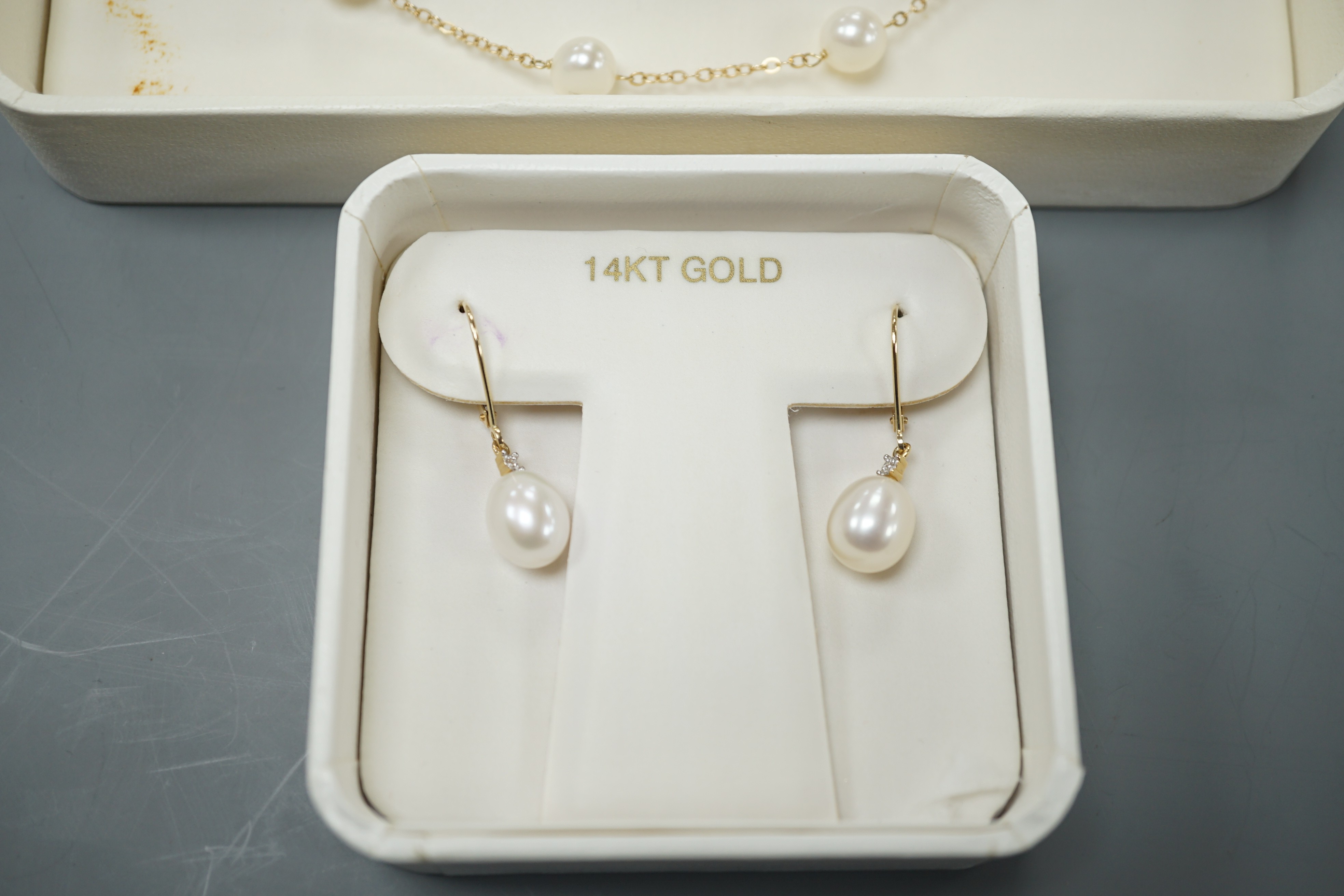 A boxed modern 14k and cultured pearl set necklace, 40cm and a pair of matching earrings.